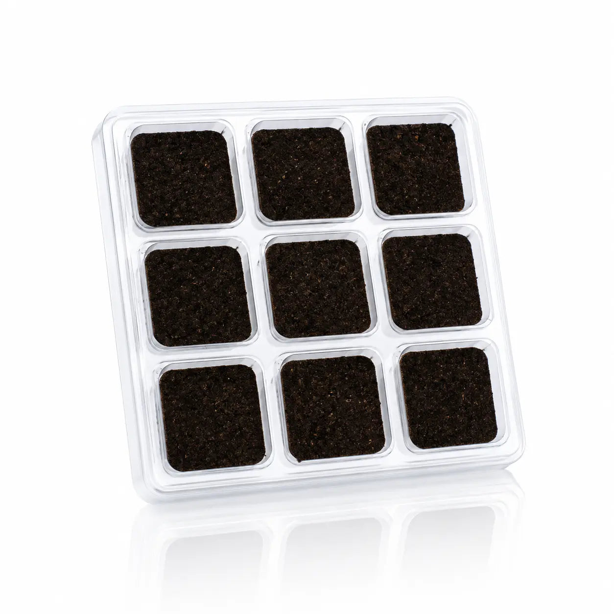 Briques d'encens Aromafume, blister en plastique transparent contenant neuf carrés d'encens de couleur brun foncé disposés en grille sur fond blanc.