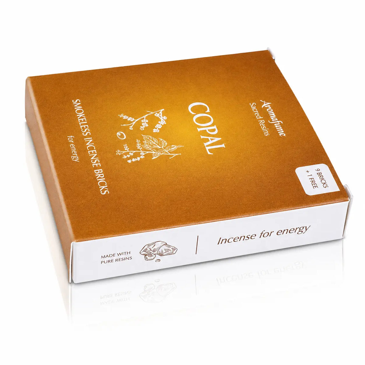 Briques d'encens Copal Aromafume, packaging rectangulaire doré et ocre avec tranche blanche, orné de délicates illustrations végétales blanches au centre.