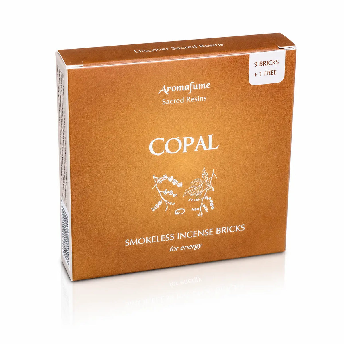 Briques d'encens Copal Aromafume, boîte cartonnée dorée et ocre ornée de délicates illustrations végétales blanches au centre.