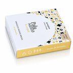 Briques d'encens Palo Santo et copal Aromafume, packaging rectangulaire blanc et jaune orné de motifs géométriques ethniques avec un demi-cercle central et tranche dorée.