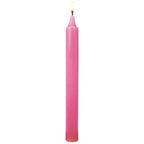 Bougie droite rose vif allumée, sur fond blanc uni, montrée en vue frontale pour mettre en valeur sa forme élancée et sa cire teintée dans la masse.