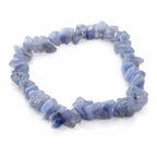 Un bracelet baroque en pierres naturelles de calcédoine, composé de petits éclats polis aux douces nuances de bleu lavande montés sur un fil élastique, présenté sur un fond blanc.