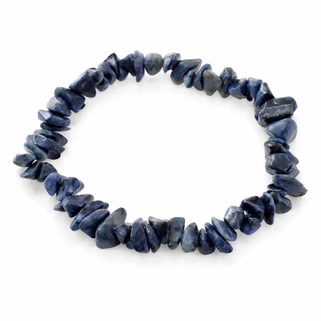 Bracelet composé d'éclats de pierres bleues foncées aux formes baroques irrégulières sur fond blanc.
