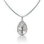 Pendentif en forme de goutte en argent avec motif d'arbre sur une base de nacre, sur un cordon gris.
