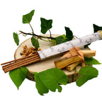 Composition d'encens Ispalla avec bâtonnets, morceaux de bois de Palo Santo et feuilles de lierre sur un socle en bois.