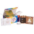 Coffret Aromafume chakras avec diffuseur métal noir et cuivré, bougie chauffe-plat, boîte multicolore ouverte et livrets « Seven Chakras Range », sur fond blanc.