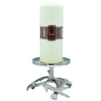Un bougeoir en métal argenté avec un socle en forme de bois de cerf, supportant une large bougie pilier de couleur crème, présenté sur un fond blanc.