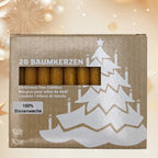 Boîte en carton contenant 20 bougies pour arbre de Noël en cire d'abeille naturelle, laissant apparaître les bougies à travers une fenêtre rectangulaire, décorée d'un motif de sapin blanc avec des bougies allumées, sur un arrière-plan festif lumineux.