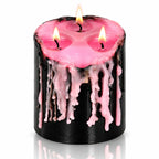 Bougie Antique Vampire Draculina 3 Mèches noire allumée laissant couler de la cire rose, sur fond blanc neutre.   