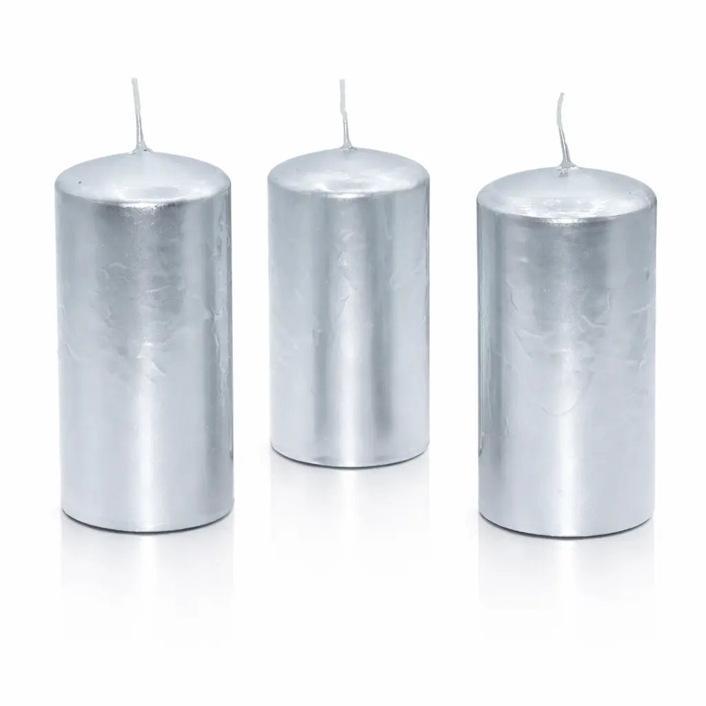 Un lot de trois bougies piliers métallisées argentées, de forme cylindrique, présentées debout sur un fond blanc avec un reflet à leur base.