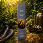 Étui d'Encens Religieux Saint Benoît de couleur bleu-gris marbré, illustré du saint tenant son bâton de croisé et un livre sacré, posé près de résines de benjoin et d'ambre.