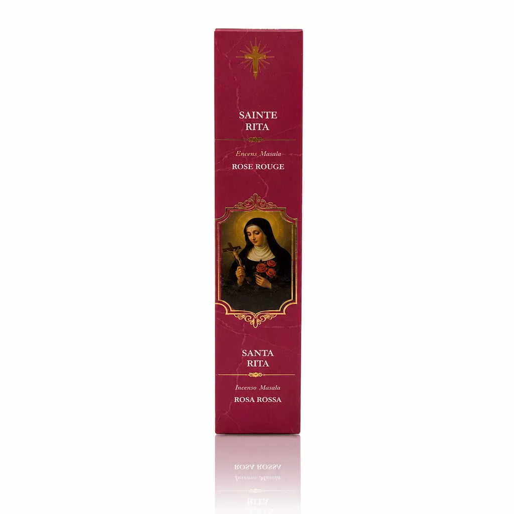 Encens religieux Sainte Rita présenté dans un étui cartonné rectangulaire rouge bordeaux, illustré de la Sainte tenant un crucifix et des roses sous une croix dorée avec des inscriptions blanches.