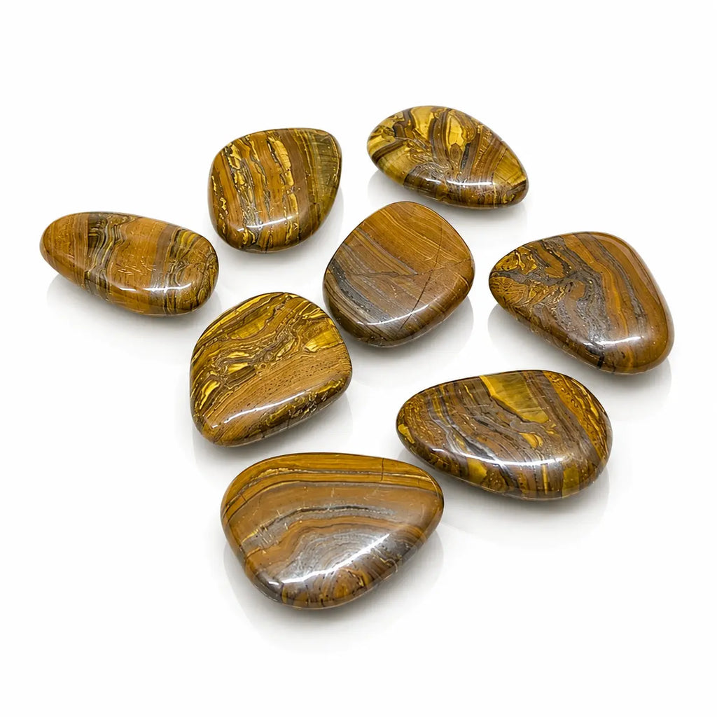 Oeil de fer : lot de galets plats et polis aux reflets dorés, bruns et métalliques, mêlant jaspe rouge, hématite et œil de tigre.