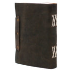 La vue arrière d'un carnet grimoire en cuir marron foncé, montrant une reliure artisanale à lacets blancs apparents sur le dos et une lanière de fermeture fixée par des rivets en laiton.