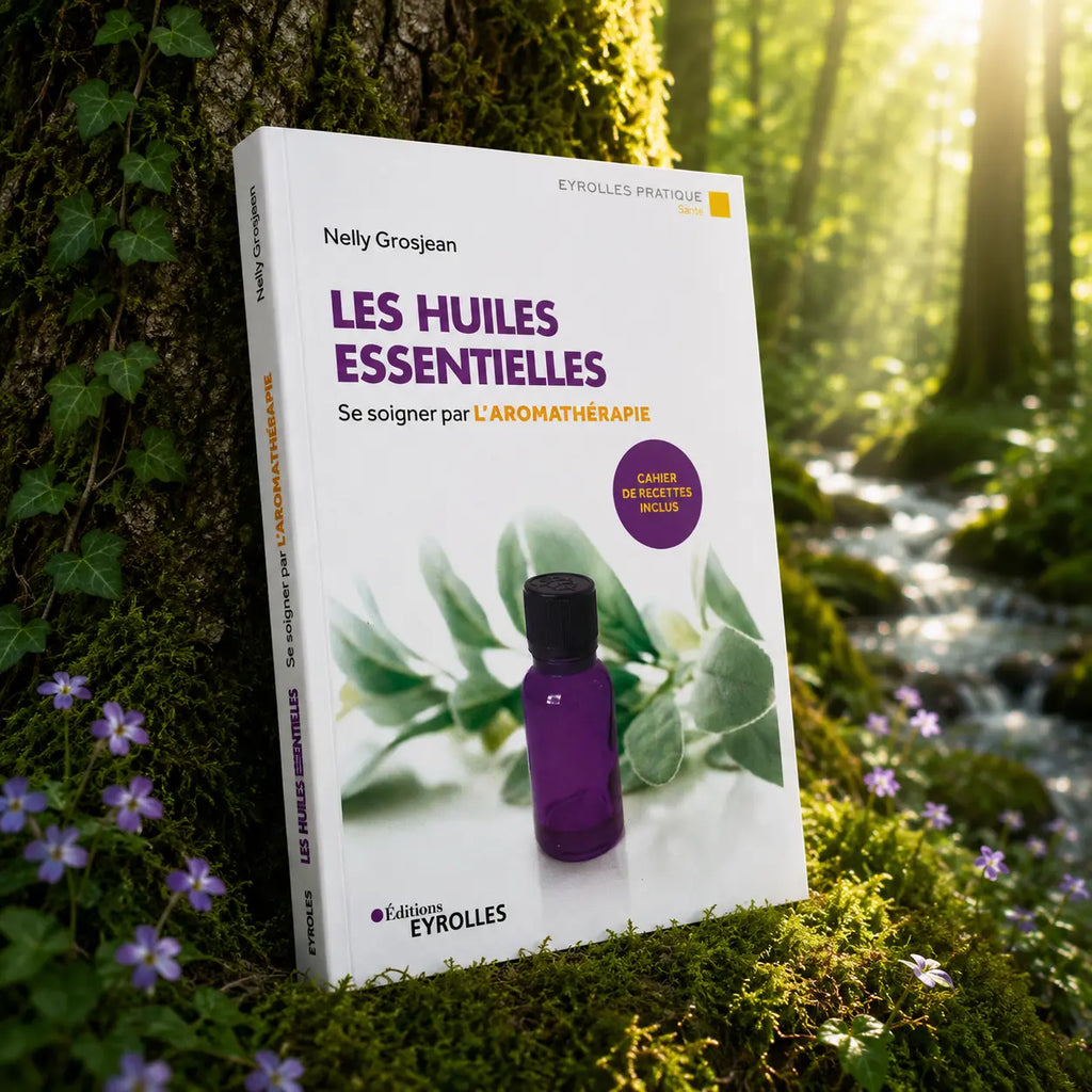 Livre Les Huiles Essentielles - Se soigner par l'Aromathérapie sur mousse sacrée au pied d'un arbre, entouré de fleurs violettes sous des rayons de soleil magiques.