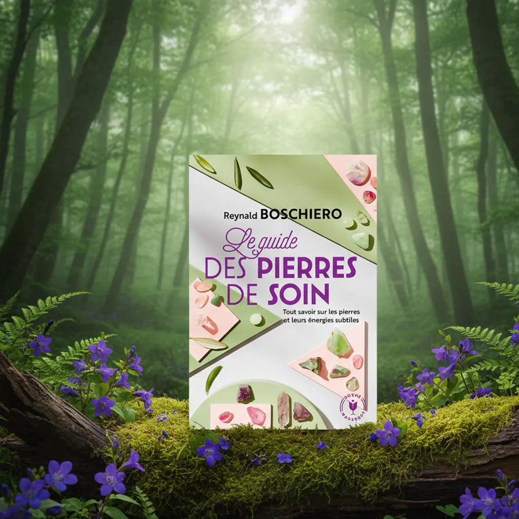 La couverture du livre "Le guide des pierres de soin" de Reynald Boschiero, illustrée par des échantillons de minéraux sur un fond graphique, mise en scène au cœur d'une forêt verdoyante et fleurie.