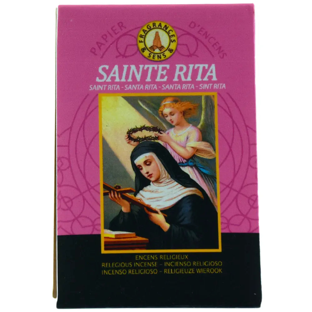 Ce carnet de papier d'encens Fragrances & Sens dédié à Sainte Rita arbore une illustration classique de la sainte avec un ange sur fond rose et noir.