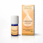 Un flacon de complexe d'huiles essentielles bio "Consolations" de la gamme Les Quantiques Olfactifs, accompagné de son étui de couleur pêche, présenté avec son reflet sur un fond blanc.