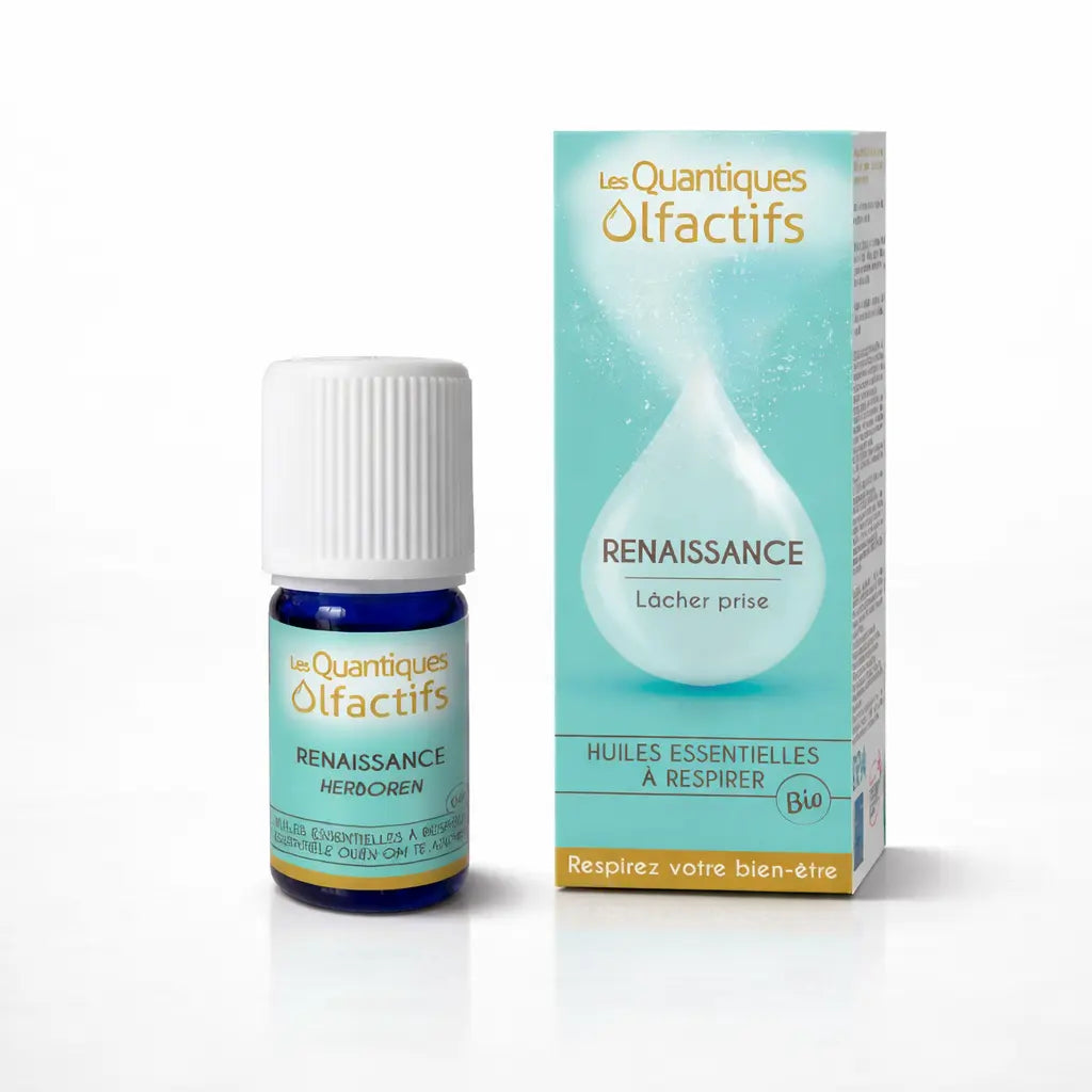 Un flacon de complexe d'huiles essentielles bio "Renaissance" de la gamme Les Quantiques Olfactifs, accompagné de son étui bleu turquoise, présenté avec son reflet sur un fond blanc.