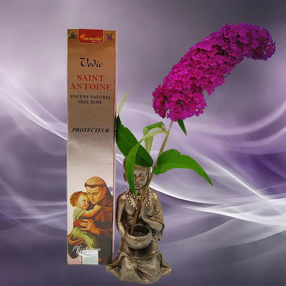 Boîte d'encens naturel Vedic Saint Antoine Miel Rose cuivrée avec illustration du saint tenant l'enfant Jésus, statuette de moine et fleur violette sur fond mauve
