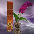 Boîte d'encens naturel Vedic Sainte Thérèse Myrrhe marron avec illustration de la sainte, statuette de moine et fleur violette sur fond mauve