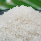 Gros plan sur des cristaux de sel infusé au Musc Blanc, texture cristalline blanche.