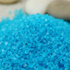 Gros plan sur les cristaux granulés bleu azur vif du sel infusé Obsession