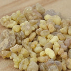Gros plan sur un monticule de morceaux de résine d'Encens Tibétain, montrant des larmes de résine de couleur jaune-beige clair et blanc cassé de taille irrégulière.